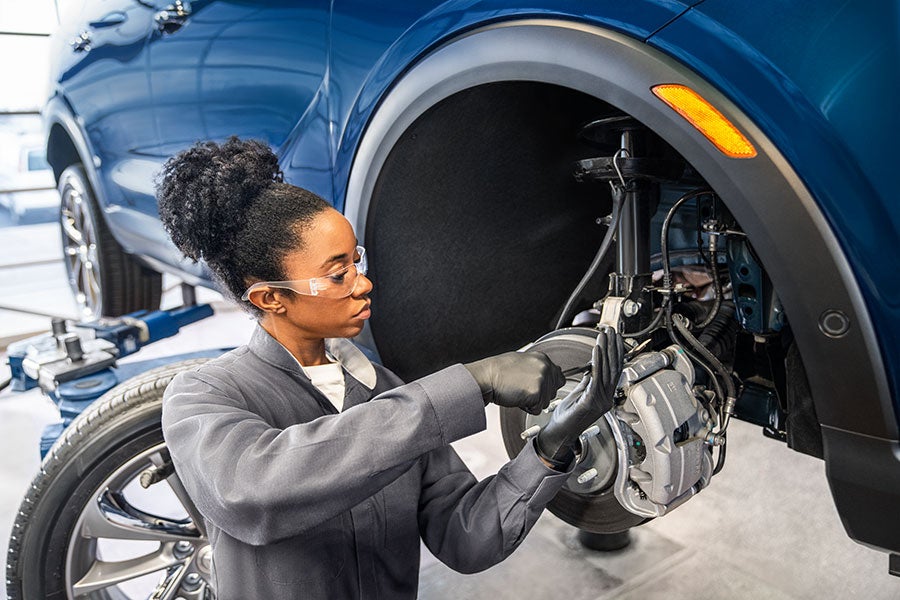 Service employee working on a car